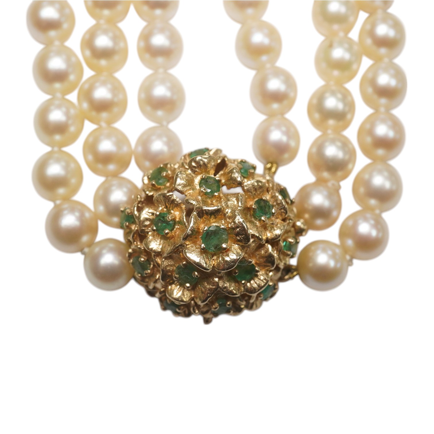 A modern triple strand culture pearl necklace, with emerald cluster set 14k clasp, 48cm. Condition - poor to fair